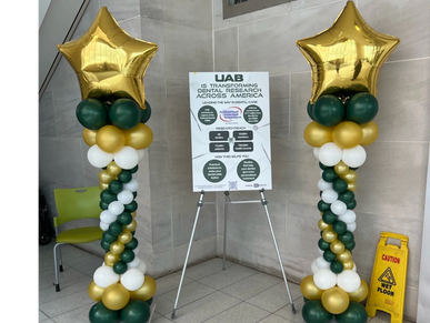 UAB balloon columns with gold star toppers at school event for party decor.