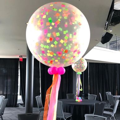 Large multi-colored neon confetti balloon centerpieces for a prom at Regions Park in Birmingham, AL.