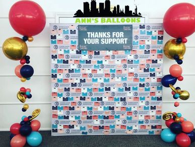Balloon columns flanking step and repeat photo backdrop for Junior League of Birmingham.