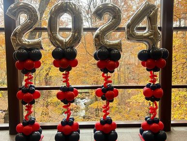 Red and blue balloon columns with oversized silver numbers for graduation event in Birmingham AL.