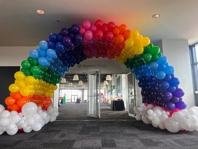 25' Rainbow Balloon Arch with Cloud Base for stunning Prom entrance at Regions Field.