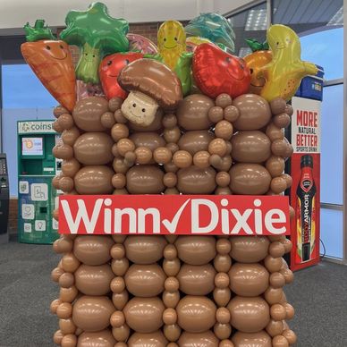 Custom balloon decor for grocery retail store in Birmingham AL featuring food accents.