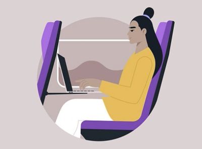 Person working on a laptop while sitting.