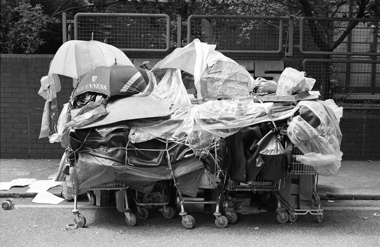 Home. Supermarket trolleys tied together to form the home and belongings of a street dweller.