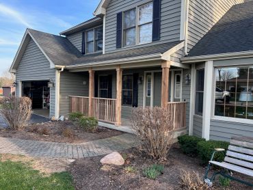 Suburban house with a porch and garage.