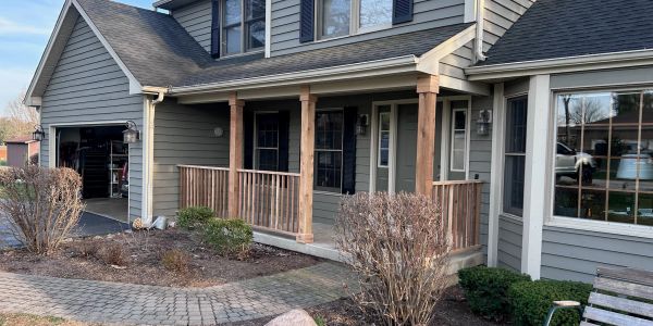 Suburban house with a porch and garage.
