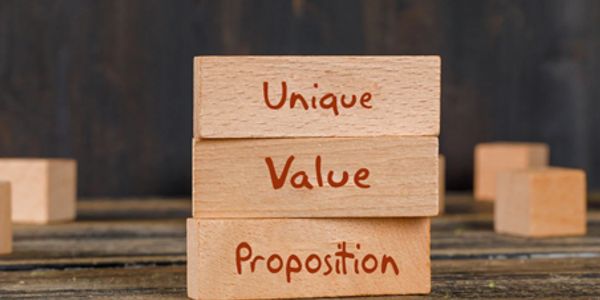 Wooden blocks with 'Unique Value Proposition' written on them, stacked together.