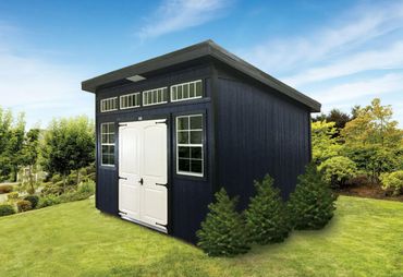 Modern black shed with white doors in a lush garden.