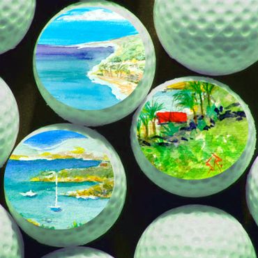 Golf balls featuring vibrant watercolor landscapes inside their dimples.