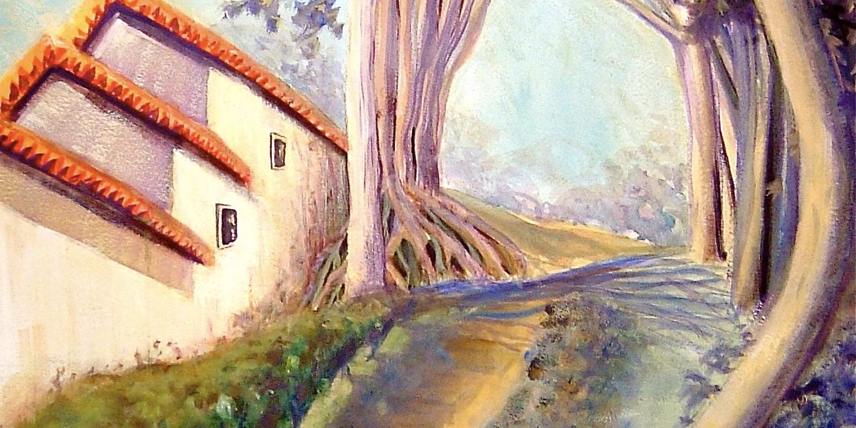 Pathway lined with trees arching over, beside a building with red-tiled roofs.