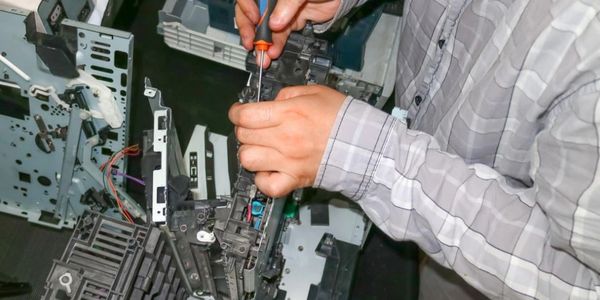 Service technician repairing office equipment