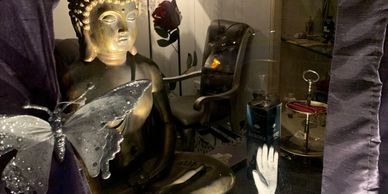 Front window of Palmistry Boutique featuring a Buddha statue.