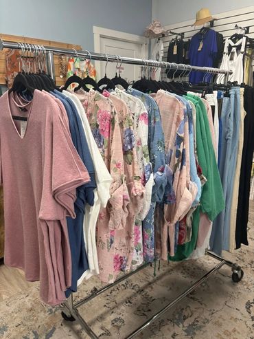 Clothes rack with colorful tops and pants.