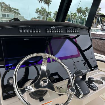 Detailer removing water spots from yacht windows