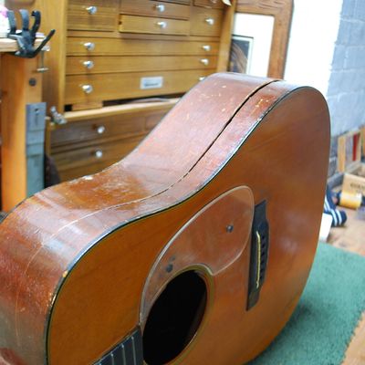Old acoustic guitar with a split back.