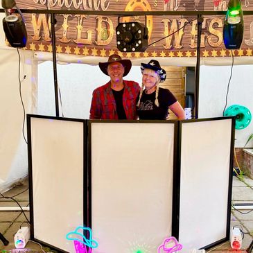 Couple in cowboy hats at a Wild West themed booth.