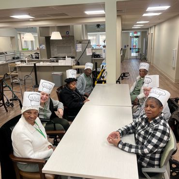 Program participants with chef hats after baking class.