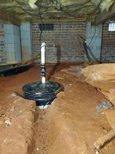 Sump pump installation in a crawl space by A Better Plumbing & Remodel Solutions.