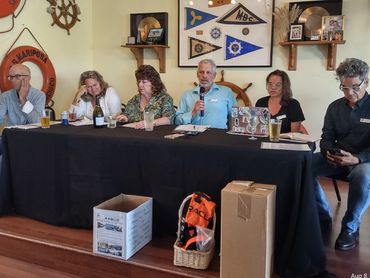 Five people seated at a table during a panel discussion.
