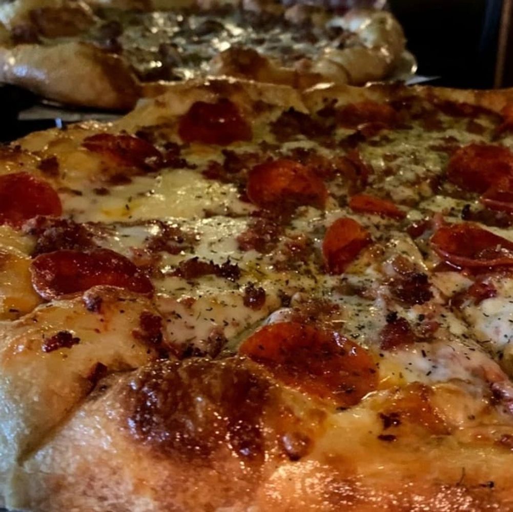 Hot and fressh signature pizza from Cafe Italiano Restaurant & Pizzeria.