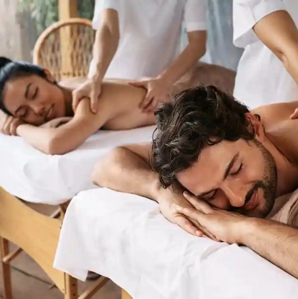 A couple enjoying relaxing massages side by side.