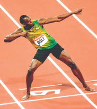 Usain Bolt striking his signature victory pose on the track.