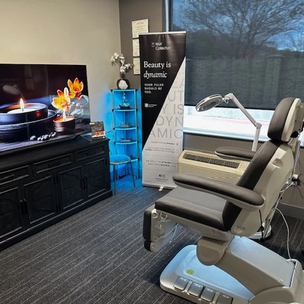 Modern treatment room with a reclining chair and calming decor.
