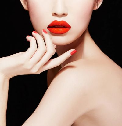 model with beautiful red lips and red nail polish