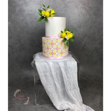 2 tier wedding cake with lemon and pink mosaic pattern, sugar lemons, foliage and flowers