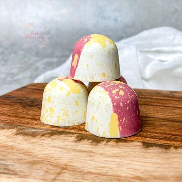 Chocolate bon bons decorated in pink and yellow