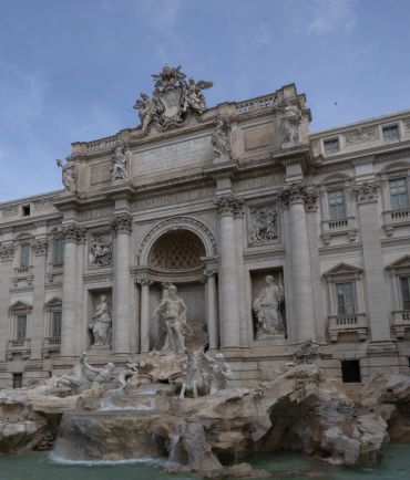 The Trevi Fountain in Rome, Italy, with statues and flowing water.