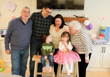 Happy multigenerational family celebrating indoors.