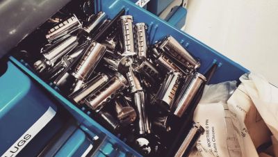 Box filled with harmonicas on a shelf.