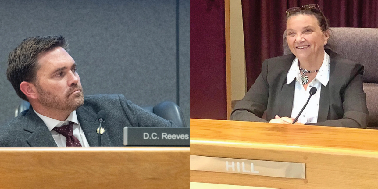 Picture of Mayor D.C. Reeves with Ann Hill at the desk at City Hall facing each other in debate over