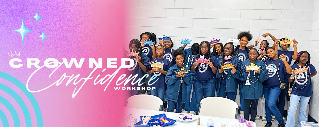 Group of girls holding crowns at confidence workshop.