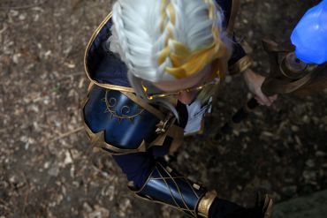 Person in detailed fantasy armor with braided white hair.