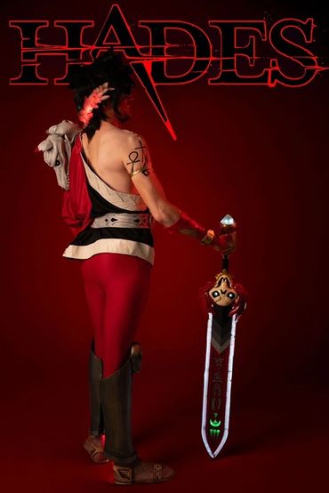 Full body, rear shot of Zagreus cosplay, with a HADES header and animation in the sword.