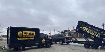 THe Mule vehicles for junk removal with yellow signage Services Residential and Commercial hauling