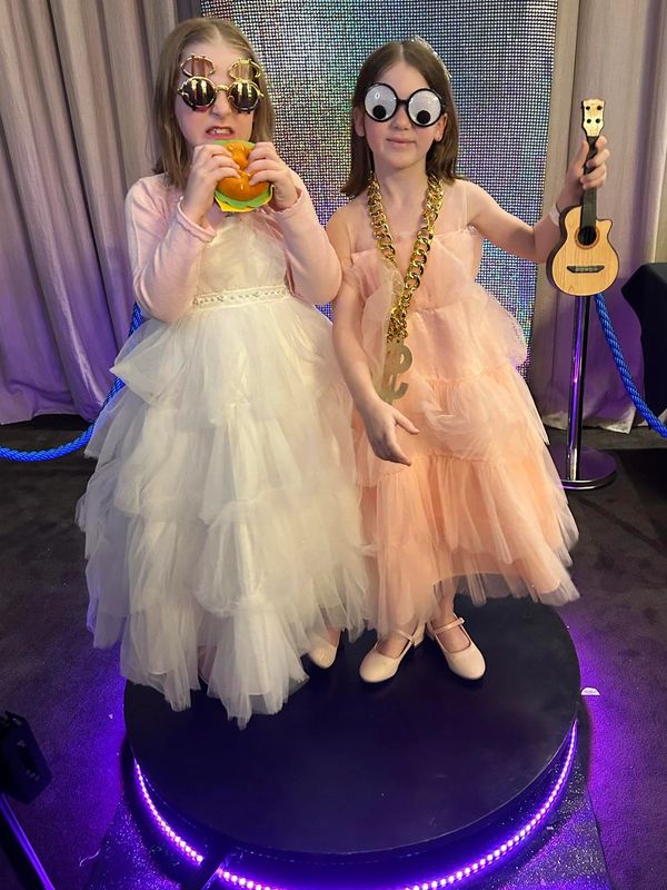 girls standing on 360 video booth