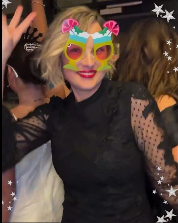 Lady with photo prop glasses and on the 360 photo booth