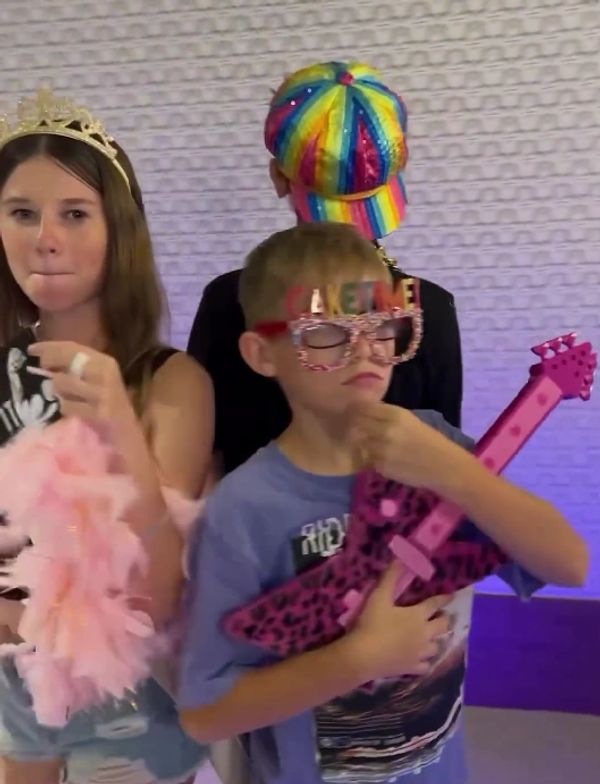 children with photo props on the 360 video booth