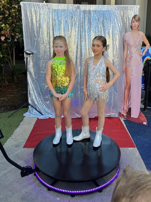 Children with photo props on the 360 photo booth or 360 video booth