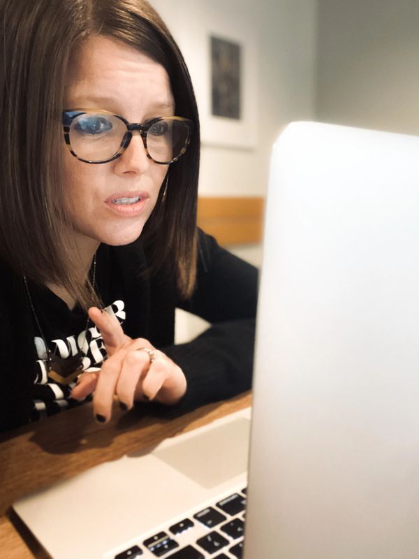 Sarah Cowan Johnson in front of a laptop