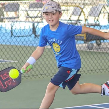 Boy taking pickleball lesson