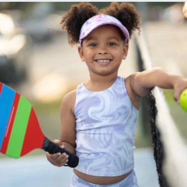 Girl playing pickleball.