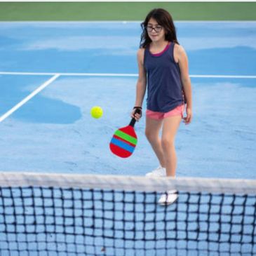 Girl playing pickleball in a lesson