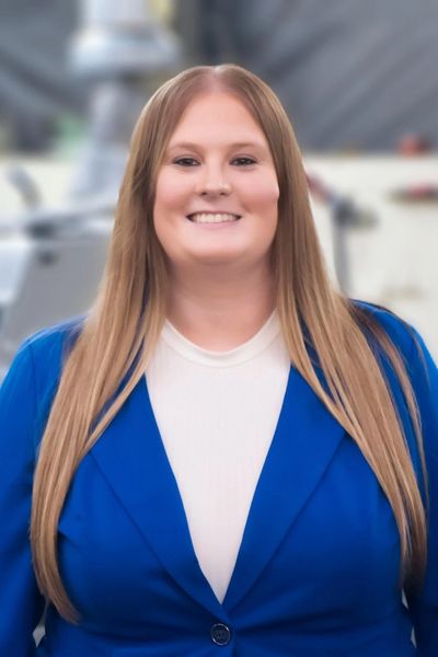Smiling woman in a blue blazer.