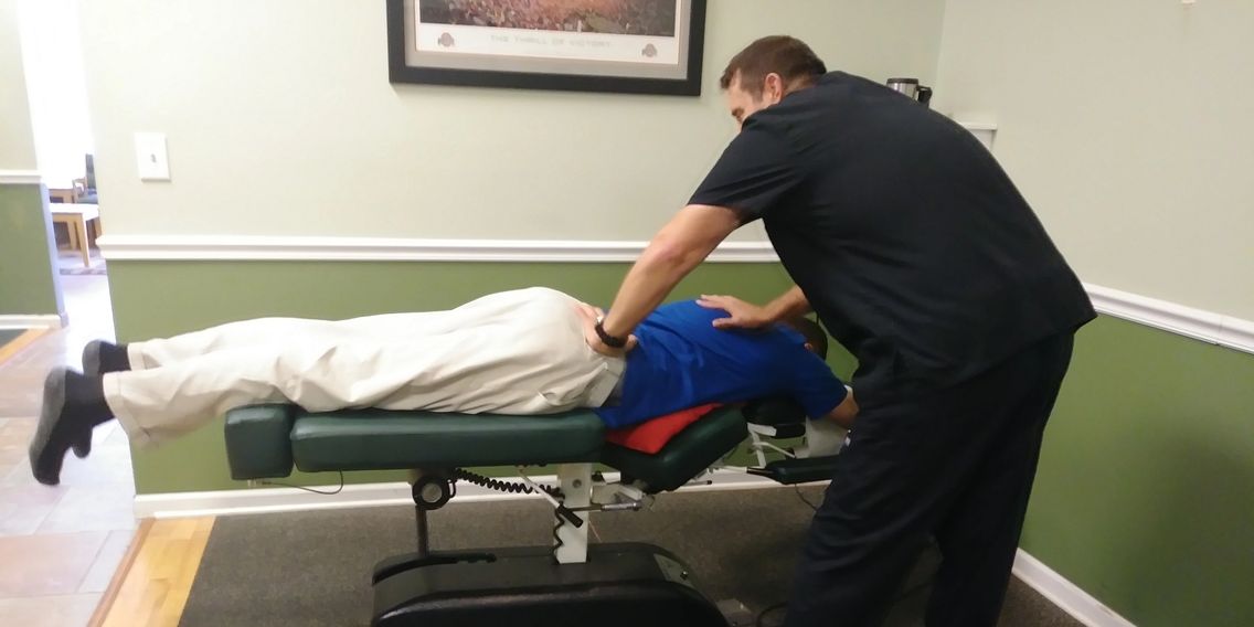 Dr. Scot giving a chiropractic adjustment on the flexion distraction table