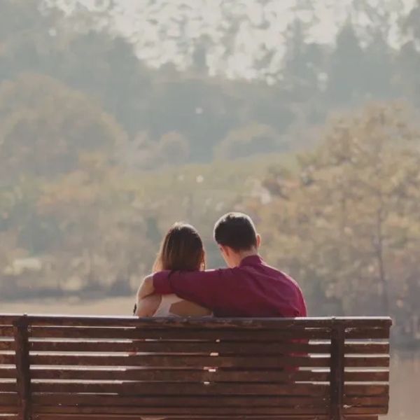 A couple thinking over options on a park bench.