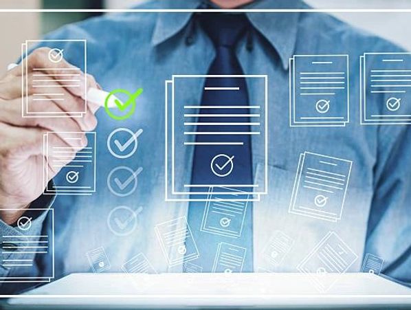 Businessman pointing to digital checklist.
